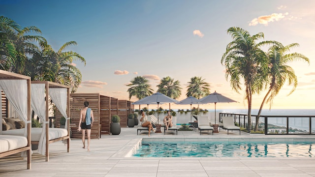 pool at dusk featuring a patio area