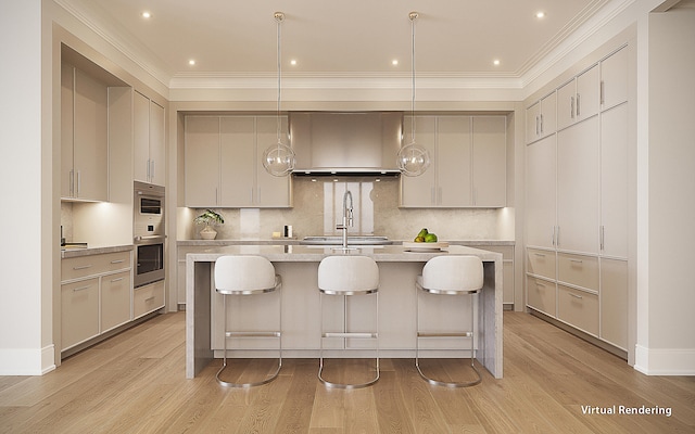 kitchen with light hardwood / wood-style floors, decorative light fixtures, ornamental molding, and a kitchen island with sink