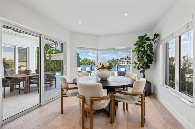 dining space with light wood-type flooring and a wealth of natural light