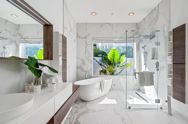 bathroom featuring vanity, a healthy amount of sunlight, and independent shower and bath