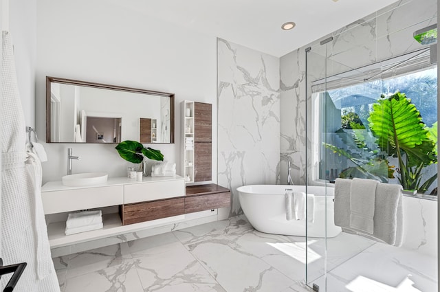 bathroom with vanity and independent shower and bath