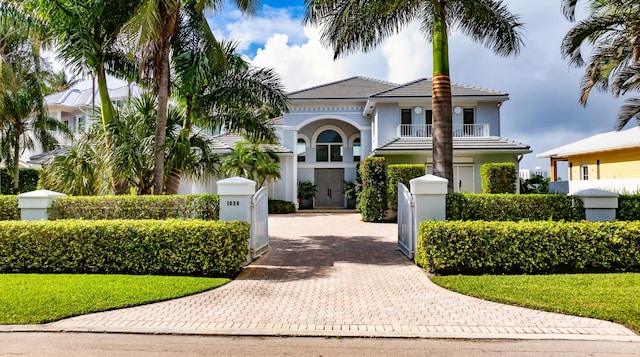 1026 Seasage Dr, Delray Beach, FL 33483 - mediterranean / spanish home with a fenced front yard, a gate, a balcony, and stucco siding