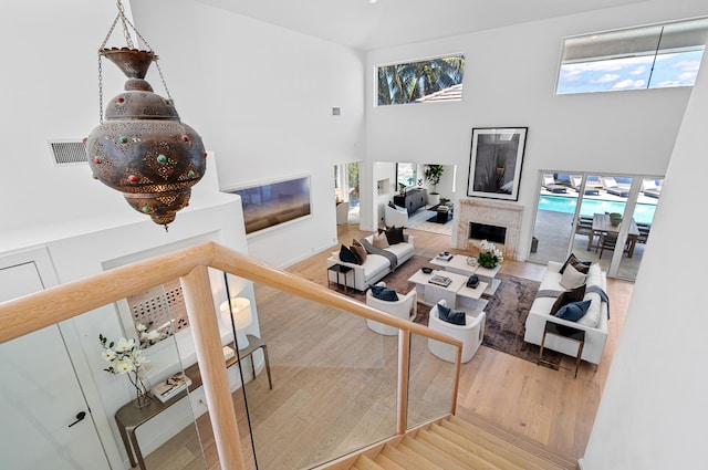 living room featuring hardwood / wood-style flooring and a towering ceiling