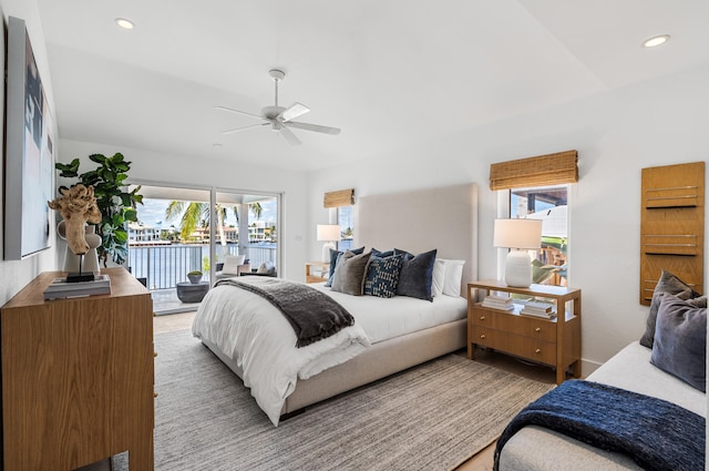 bedroom with ceiling fan, access to outside, and multiple windows