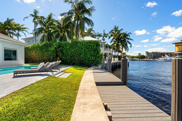 1026 Seasage Dr, Delray Beach, FL 33483 - dock area with a water view, an outdoor pool, a patio, and a yard