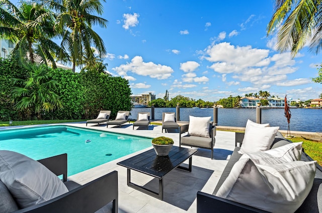 view of pool with a patio area, a water view, and an outdoor hangout area