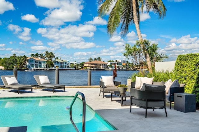 view of swimming pool featuring a patio area and a water view