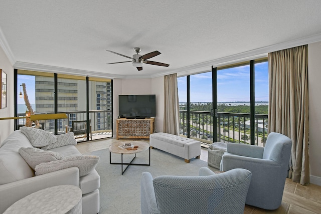 living room with crown molding, a wall of windows, a textured ceiling, and ceiling fan