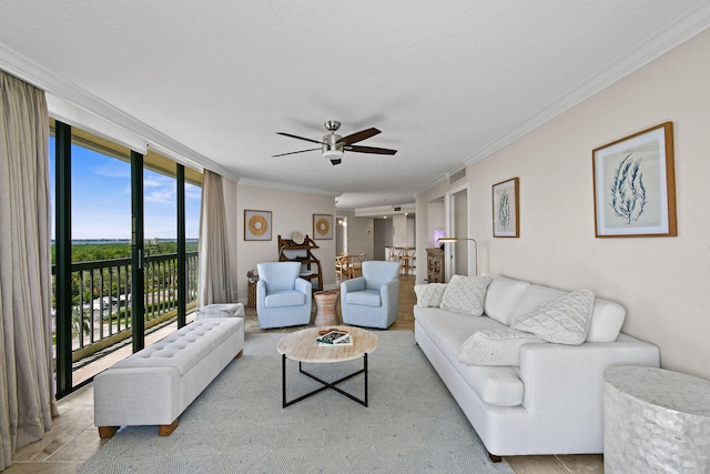 living room featuring ornamental molding, ceiling fan, and floor to ceiling windows