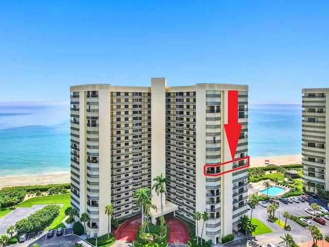 view of property featuring a beach view and a water view