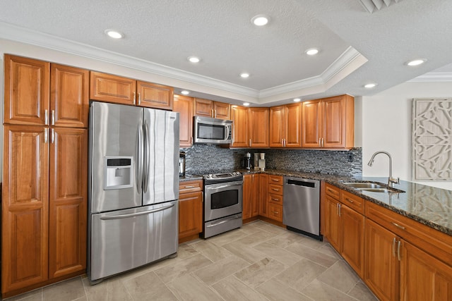 kitchen with stainless steel appliances, tasteful backsplash, dark stone countertops, sink, and crown molding