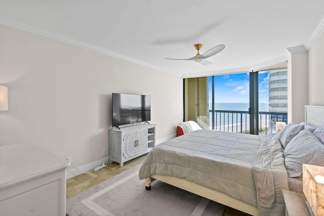 bedroom featuring ceiling fan, light hardwood / wood-style flooring, a wall of windows, crown molding, and access to outside