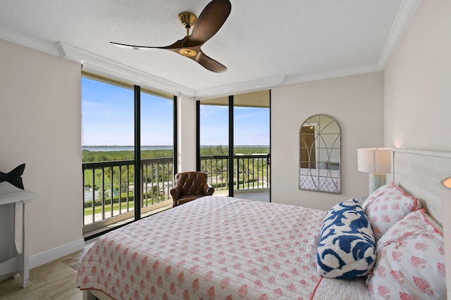 bedroom with access to exterior, multiple windows, ceiling fan, and crown molding