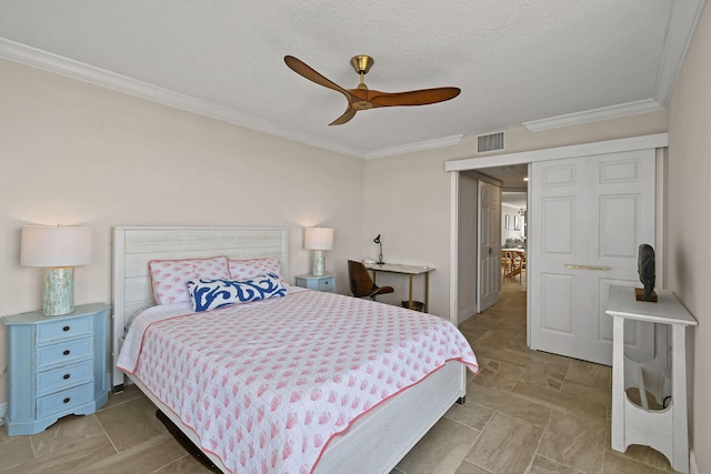 bedroom featuring ornamental molding, ceiling fan, and a textured ceiling