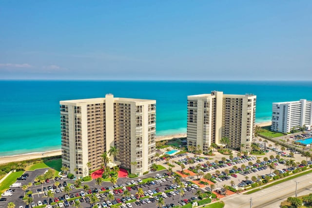 drone / aerial view featuring a water view and a beach view