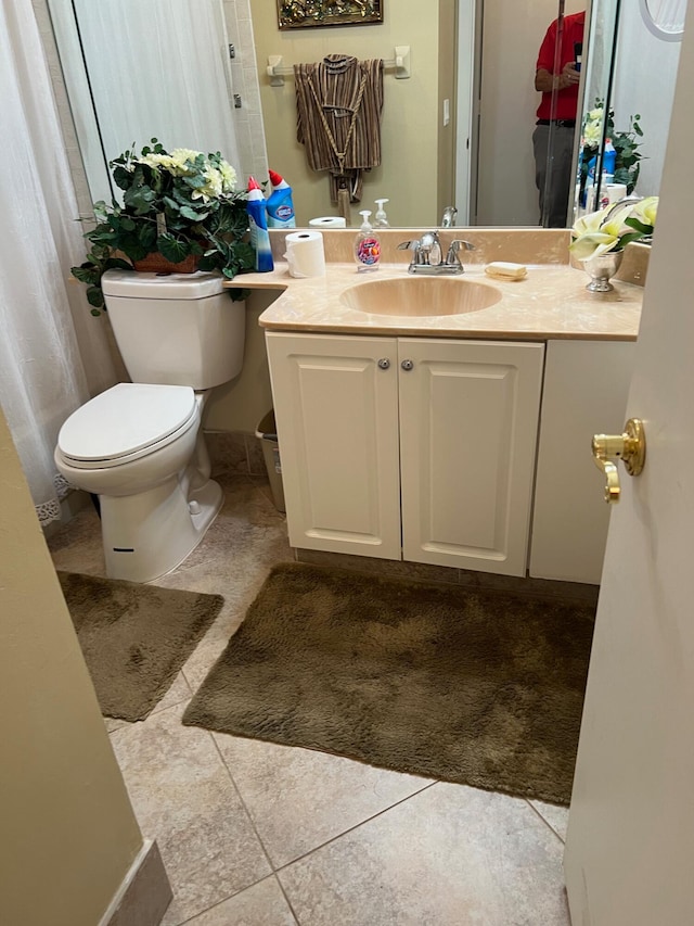 bathroom with vanity, toilet, and tile patterned flooring