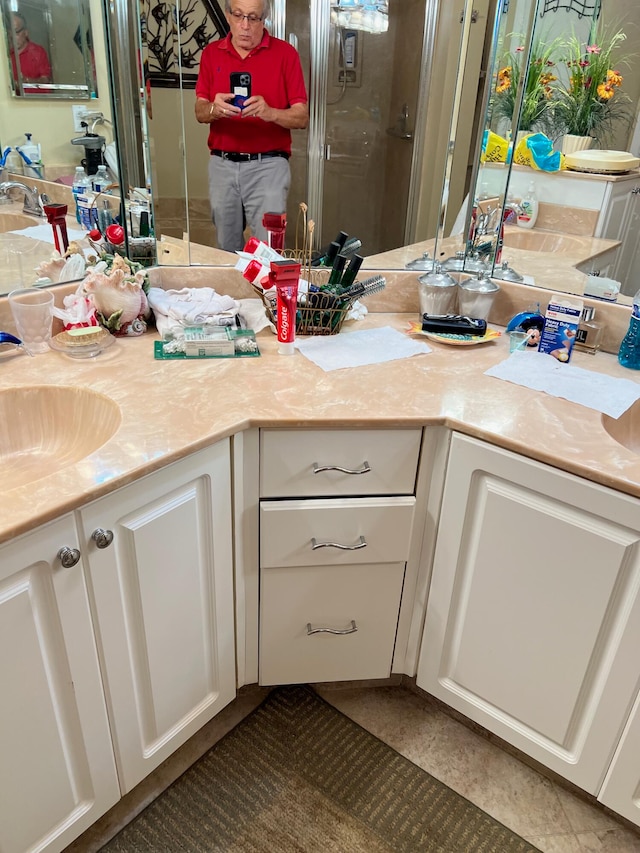 bathroom with a shower with door and vanity