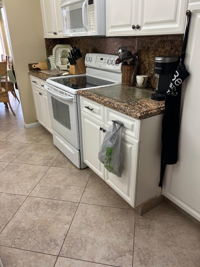 kitchen featuring decorative backsplash, white cabinetry, light tile patterned floors, and white appliances