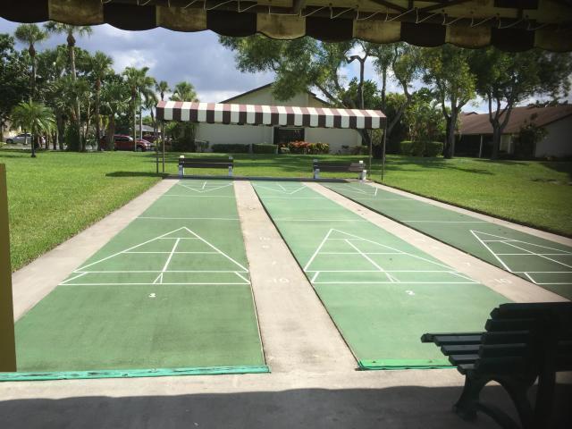 7926 Willow Spring Dr Unit 1325, Lake Worth, FL 33467 - view of property's community with a lawn and shuffleboard