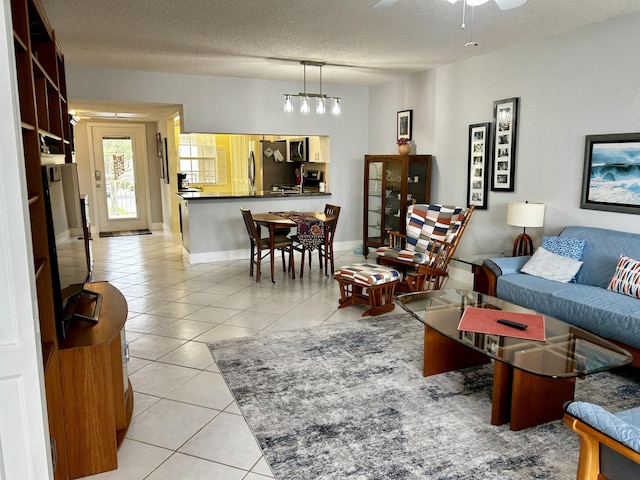 tiled living room featuring ceiling fan and a textured ceiling