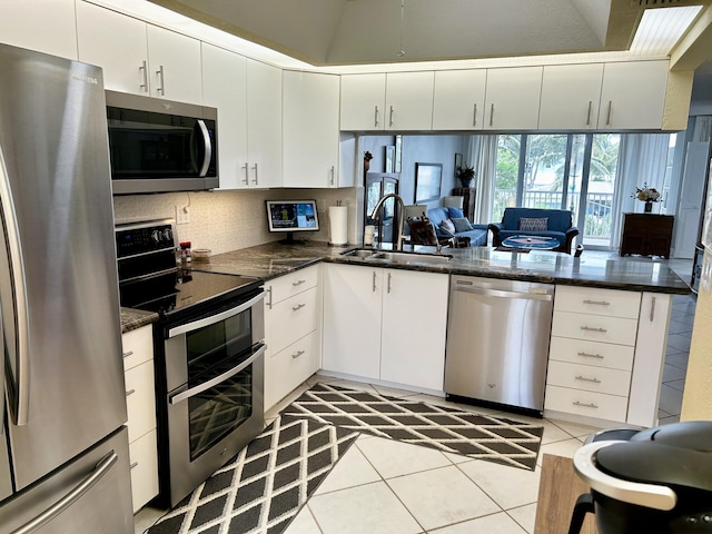 kitchen with appliances with stainless steel finishes, sink, and white cabinets