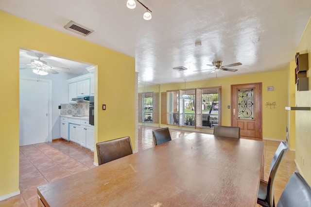 dining area with ceiling fan and light tile patterned floors