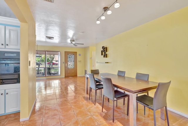 dining space featuring ceiling fan and light tile patterned flooring