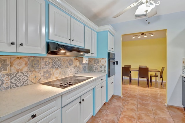 kitchen with decorative backsplash, white cabinets, and black appliances