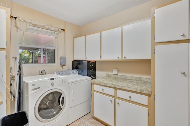 washroom featuring cabinets and independent washer and dryer