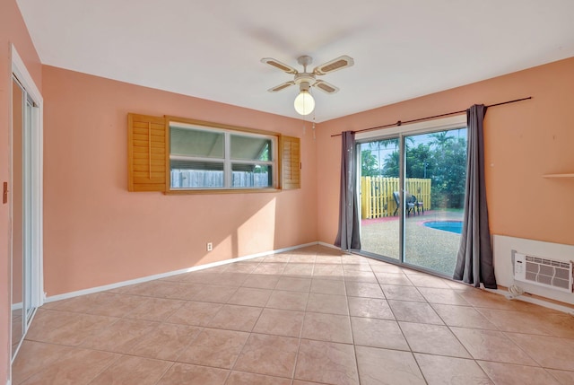 spare room featuring ceiling fan and light tile patterned floors