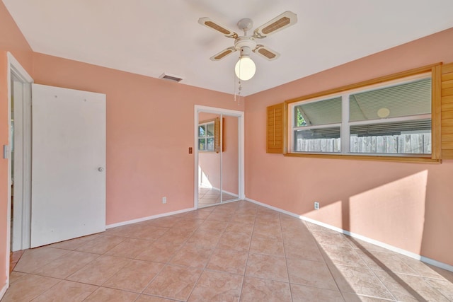 spare room featuring ceiling fan and light tile patterned floors