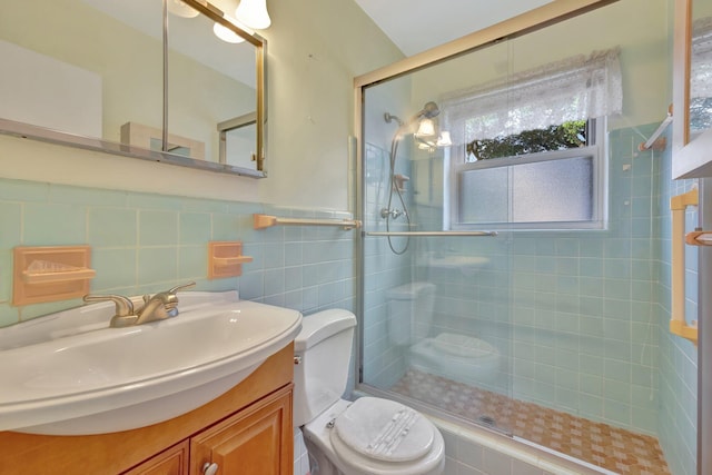 bathroom featuring an enclosed shower, vanity, toilet, and tile walls