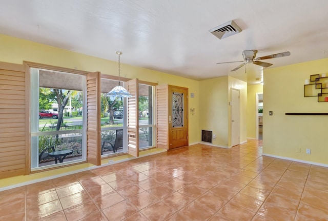 unfurnished room with ceiling fan and light tile patterned floors