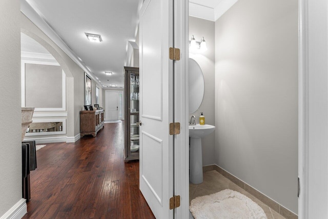 corridor featuring hardwood / wood-style floors, visible vents, and baseboards