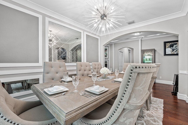 dining room with a chandelier, arched walkways, visible vents, and wood finished floors