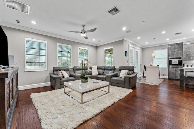 living area featuring ornamental molding, dark wood-style flooring, visible vents, and baseboards