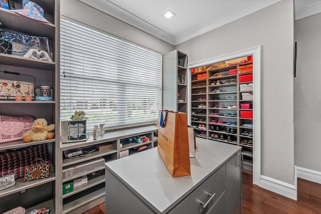 office area featuring dark wood-type flooring, crown molding, and baseboards