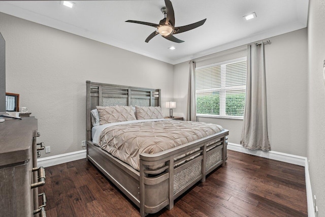 bedroom featuring dark wood-style floors, baseboards, and crown molding