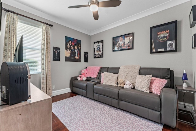 living room with crown molding, baseboards, dark wood finished floors, and a ceiling fan