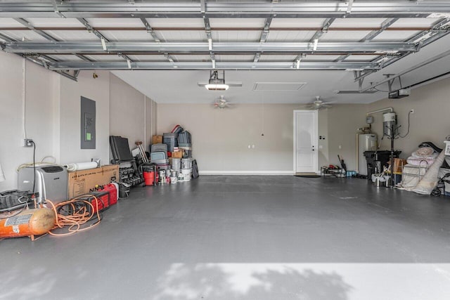 garage featuring a garage door opener, gas water heater, and electric panel