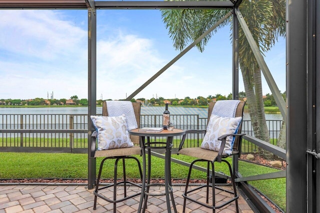 sunroom / solarium featuring a water view and plenty of natural light