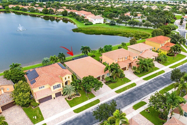 birds eye view of property with a water view and a residential view