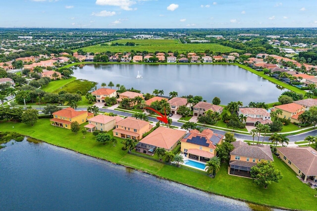 birds eye view of property with a water view and a residential view