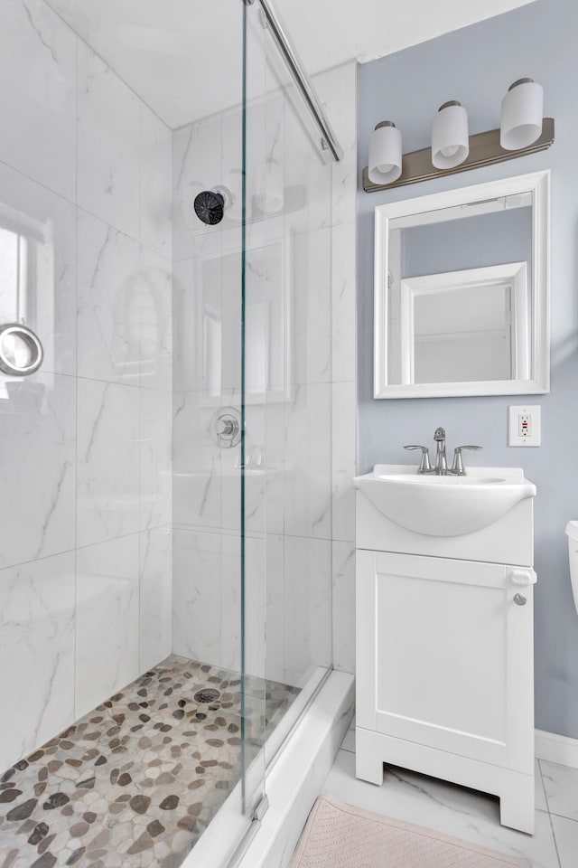 bathroom with vanity, a shower with shower door, and toilet