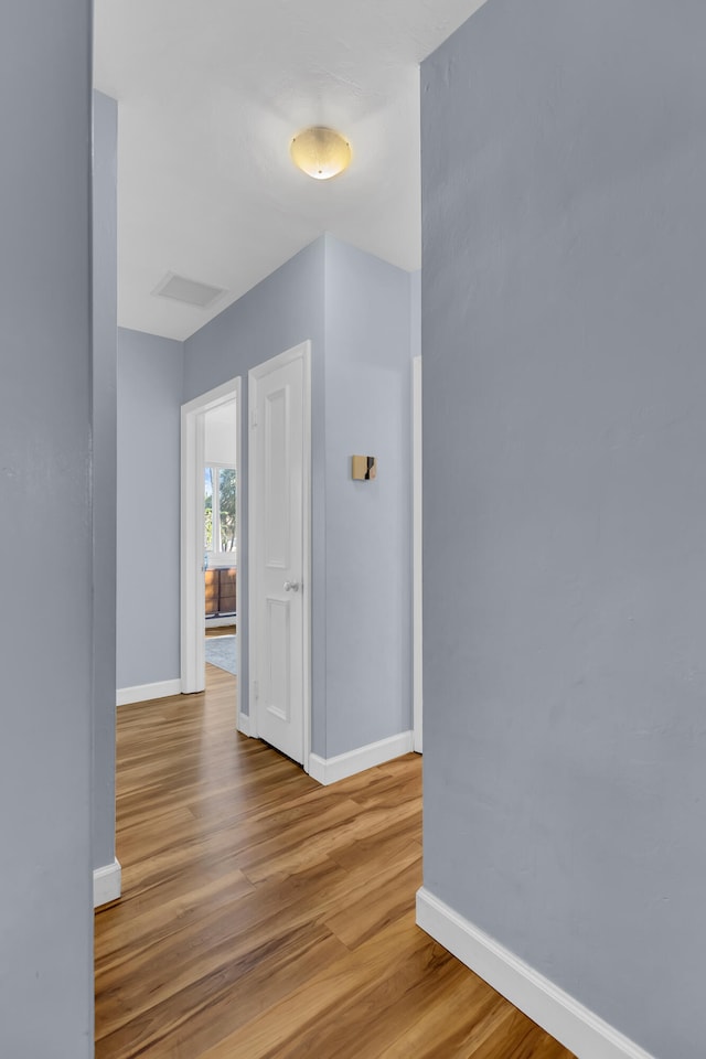 corridor featuring light hardwood / wood-style floors