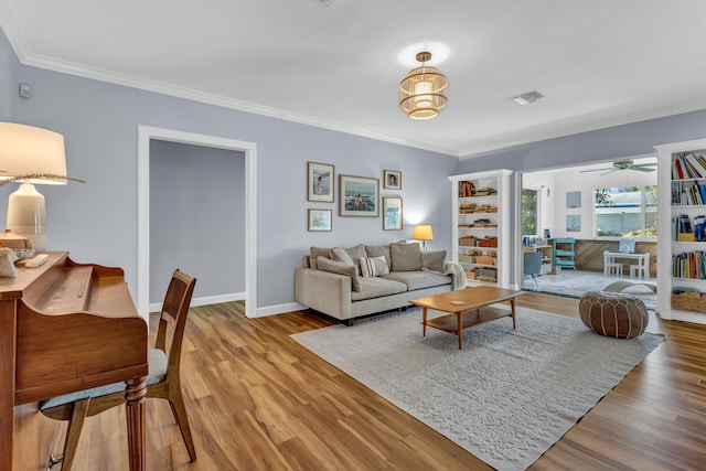 living room featuring crown molding, hardwood / wood-style flooring, and ceiling fan