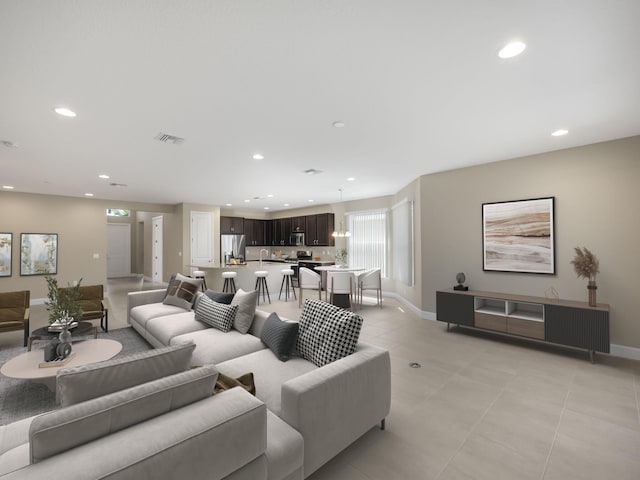 living room featuring a notable chandelier and light tile patterned flooring