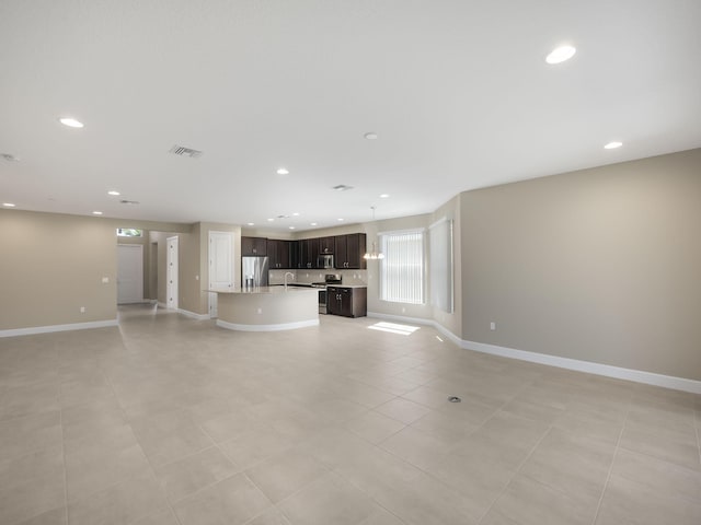 unfurnished living room with light tile patterned flooring