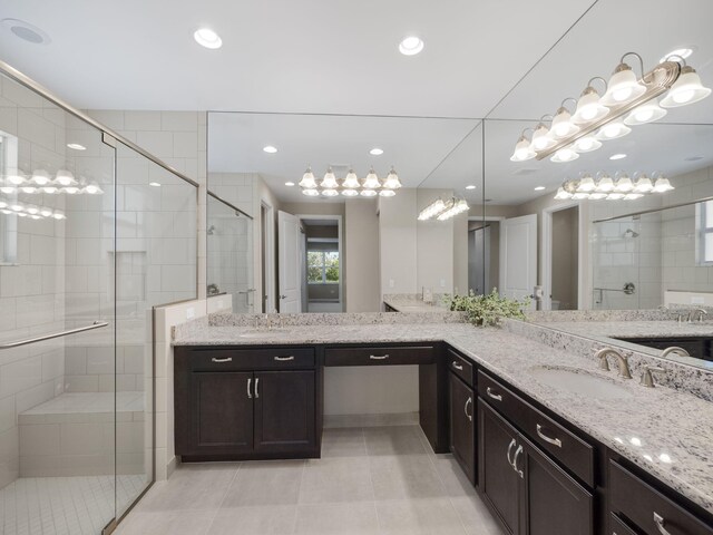 bathroom featuring vanity, tile patterned floors, and walk in shower