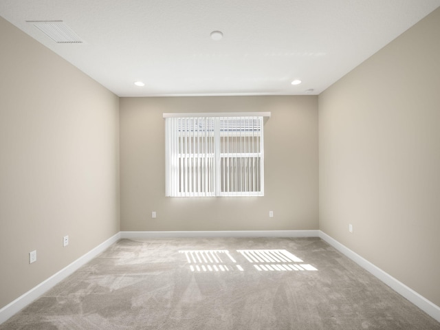 empty room featuring light carpet